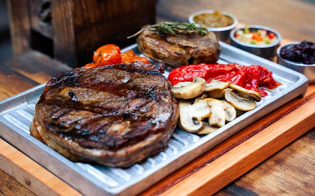 Corte de carne a las brasas servido sobre tabla de madera